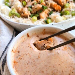 bang bang sauce recipe with tofu being dupped in with a bowl of asian stir fry vegetables and rice